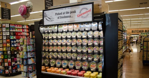pre-packaged salads at a grocery store in pusher trays